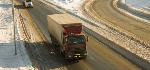 Trucks on snowy winter highway road