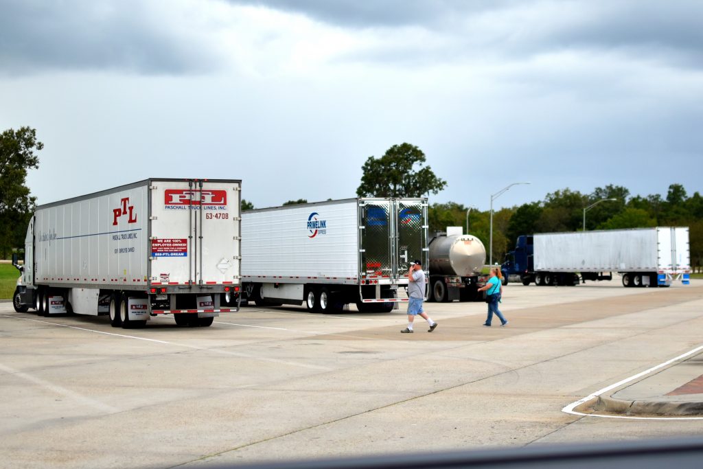 Truck Driver walking to truck at highway rest-stop