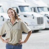 Woman standing in front of semi-trucks