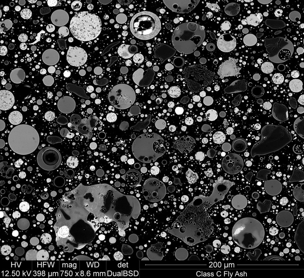 Photomicrograph made with a scanning electron microscope (SEM) and back-scatter detector: cross section of fly ash particles at 750x magnification