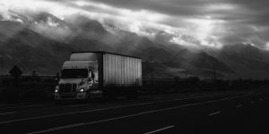 Truck on Highway next to mountain - B&W