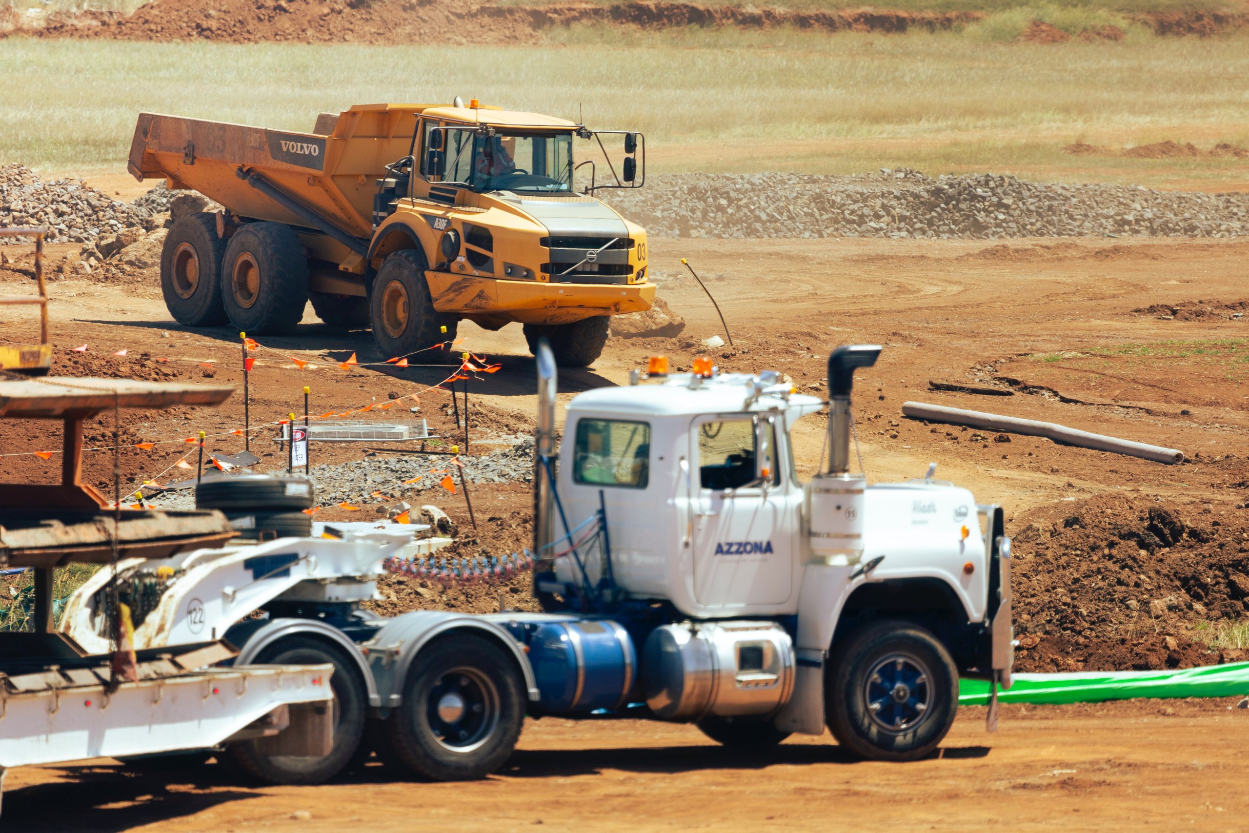 Photo by Troy Mortier on Unsplash, Heavy Equipment in Field with off road HD Truck