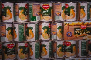 Del Monte Foods Chapter 11: Massive $1B Bankruptcy Shakes Supply Chain - Fast-Moving Sale, Freight Fallout, and Path Forward 1 DelโฏMonte canned pear halves displayed with โBuy Americanโ banner.