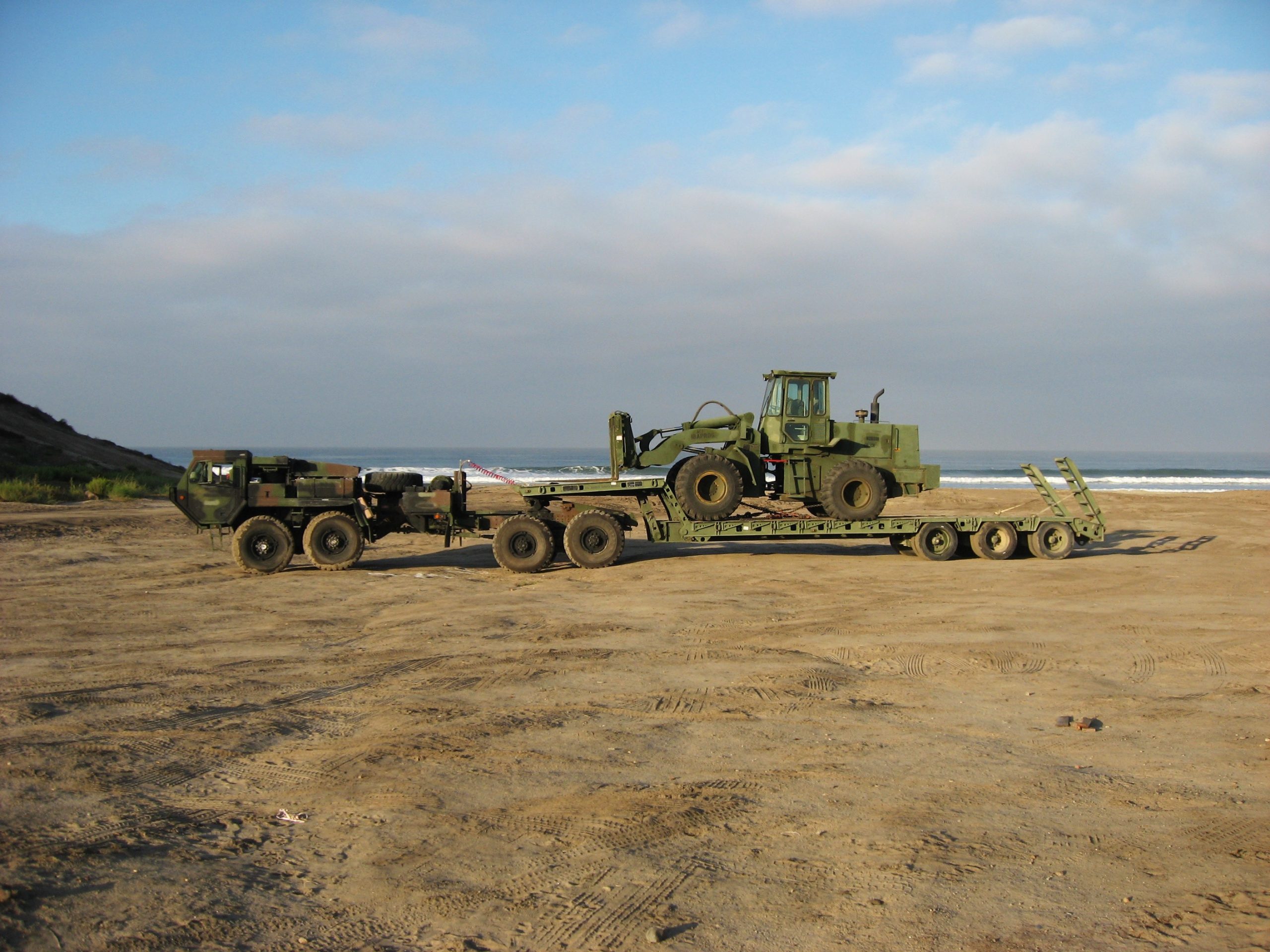 The M870A2-S is a three axle Medium Heavy Equipment Transporter (MHET) designed to haul a payload of 80,000 lbs. (40-ton) in conjunction with an LVS MK48/MK16 fifth wheel truck tractor, LVSR tractor, or a M931A2 truck tractor. Most of the specifications for the M870A2S are identical to the M870A2 except for: Updated with Anti-lock Brake System (ABS); Updated with air ride suspension: air springs, shock absorbers, and height control value: and Non-Driving Tapered spindle axles. Marine Corps Base, Camp Pendleton, CA.
