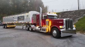 Page Trucking Goulet merger: Page Trucking and Goulet Trucking Merger 500‑Truck Specialized Bulk Carrier Takes Shape 10 Page Trucking maroon conventional tractor hauling a polished aluminum Page-branded bulk trailer, parked on a misty morning.
