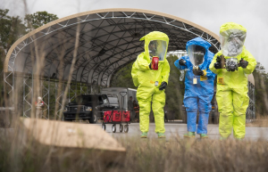 Driverless Hazmat Trucking: 9 Critical Operational Takeaways for Hazmat Fleets From PHMSA’s HM‑266 ANPRM 7 Hazmat responders in protective suits walking toward a decontamination area during a training exercise.