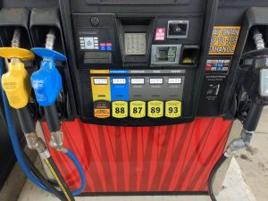 HM-265 Fuel Compliance: 7 Cost-Saving Changes—Efficiency Gains, Compliance Watchouts 4 Gas pump with three labeled nozzles for E85 flex fuel, E15 unleaded 88, and regular gasoline. shows HM-265 Fuel Compliance