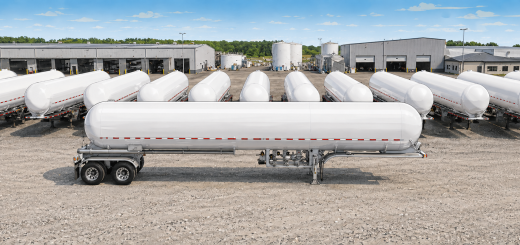 Illustrated wide aerial view of multiple white MC 331-style LPG cargo tank trailers lined up in an industrial yard, with warehouses and storage tanks in the background.