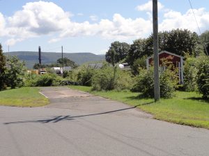 Roadcheck ELD Enforcement: 12 Major Enforcement Risks for Fleets in 2026 1 Commercial truck entering a weigh station lane beside a scale facility.