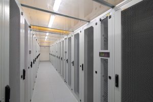 Water Tank Transport Demand Faces 7 Critical Shifts in a Strained Infrastructure Market 3 Cold aisle inside a data center with rows of server cabinets.