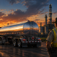Texas petroleum theft illustration showing an over-the-road petroleum tanker, refinery gate, and state trooper during a transport-security inspection scene.