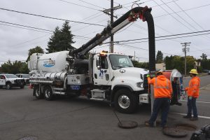 Water Tank Transport Demand Faces 7 Critical Shifts in a Strained Infrastructure Market 6 Vactor 2100 Plus sewage vacuum truck operating in downtown Olympia, Washington.