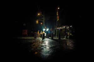 Heavy-Duty Truck Excise Tax Repeal: 7 Powerful Benefits and Risks for Tank Fleets 14 Alt Text:Road crew working at night with construction lights and equipment at an intersection.