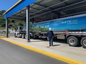 Renewable Diesel Mandate Reality Check: 7 Critical Pressures Facing U.S. Fuel Markets 10 Renewable diesel mandate terminal scene with a Neste MY Renewable Diesel tanker truck parked beneath a covered loading canopy.