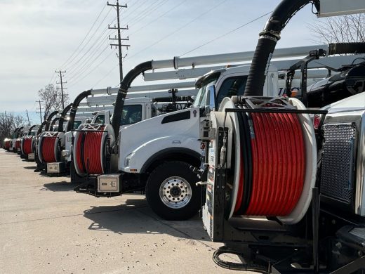 JDC vacuum truck rental fleet lined up at a company facility.