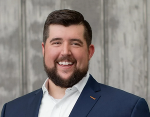 Quantix Names Nate Gesse CEO After Lender Restructuring 3 Nate Gesse smiling in a navy suit in the official portrait for the Quantix CEO transition.