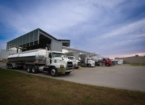 ARKO’s $235 Million USPP Deal Would Add Two Terminals and a Fuel Fleet 3 U.S. Petroleum Partners tankers positioned beneath a terminal fuel-loading rack.
