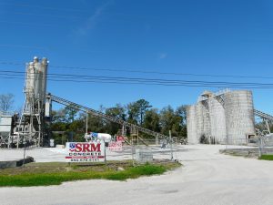 Construction Cost Pressure Threatens Bulk-Hauling Demand 3 Storage silos, conveyors and a concrete mixer truck at a ready-mix plant in Tallahassee, Florida.