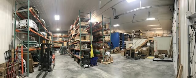 SEMO Tank at 50: From Dairy Equipment to Broader Tank-Fleet Support 3 Storage racks, pallets and a forklift inside a parts warehouse with an open concrete aisle.