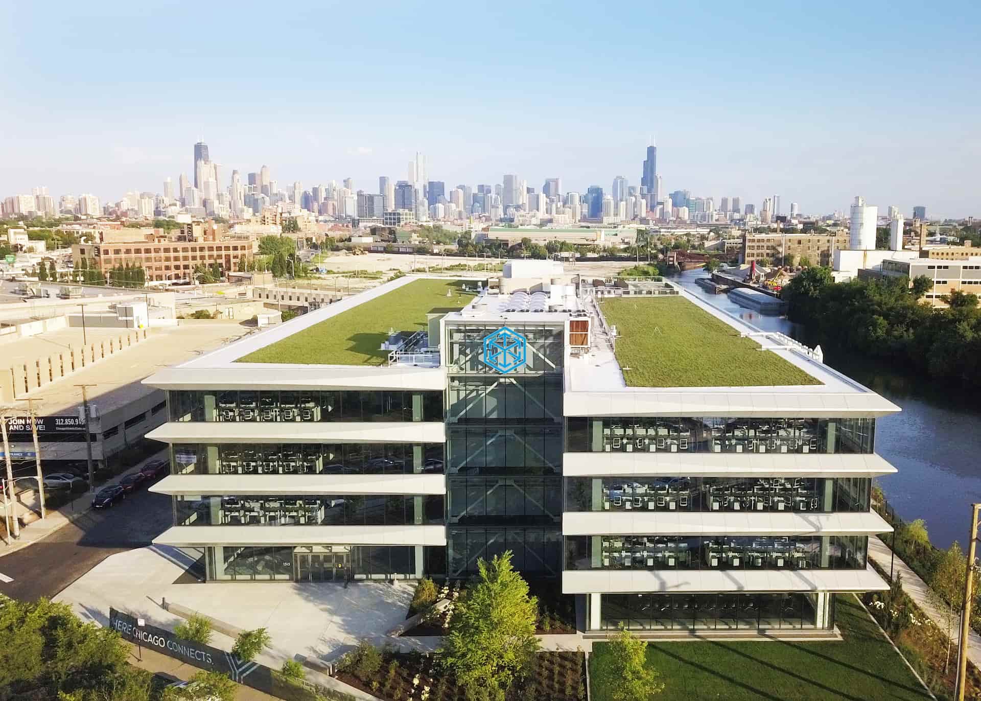 C.H. Robinson’s Chicago Central office beside the river with the Chicago skyline behind it